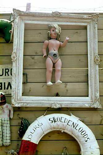 Framed doll in the Amsterdam Flea Market photographed by pop artist Trevor Heath